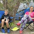 A mother and child sitting in camping chairs