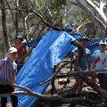 A group of young participants building a hut