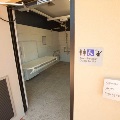 An automatic door open showing a changing table and accessible bathroom facilities
