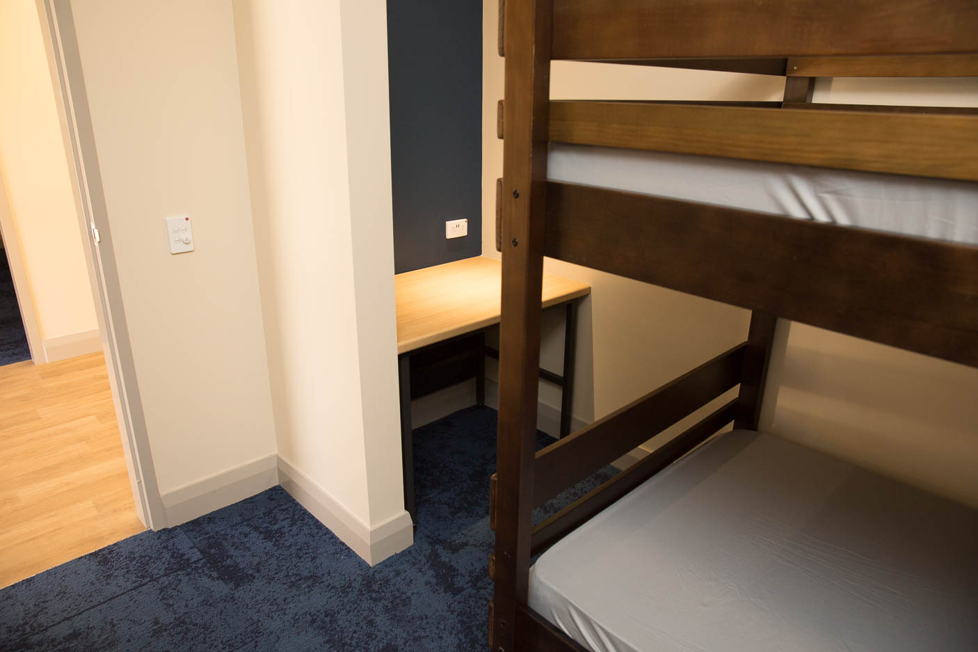 An interior view of a bunk bed and a table inside a new dormitory