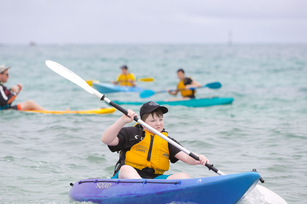 Aboypaddlingontheocean