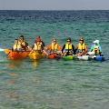 A group of participants holding their kayaks together