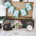 Wedding decorations including an old luggage case, camera, clock and flowers