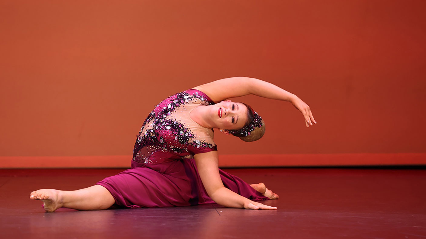 Sidney North practicing calisthenics on a dance floor and in a jewelled dance costume