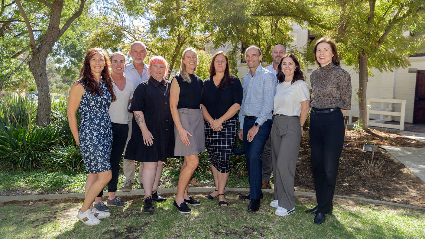 10 DLGSC attendees and presenters of the 2024 trails forum pose for a group photo.